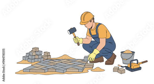 A construction worker in a hard hat and overalls kneels, using a mallet to lay gray paving stones on a sandy ground with tools nearby.