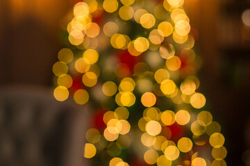 Luxury Christmas bokeh background with golden fairy lights and blurred holiday decor.