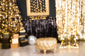 Luxury Christmas bokeh background with golden fairy lights and blurred holiday decor.