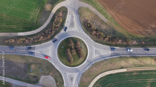 Aerial top-down view of a roundabout with cars