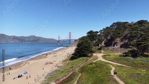 A dolly-in aerial drone video capturing the Golden Gate Bridge from the vantage point of Baker Beach.
