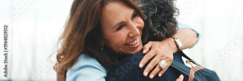Elderly man meets his girlfriend on the promenade, hugging joing meeting. Panoramic. Panoramic