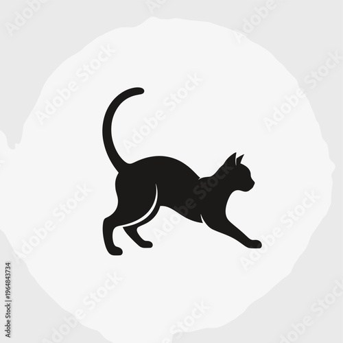 A sleek black cat silhouette is captured in a dynamic pose, showcasing its elegant form against a textured, light-colored circular background.
