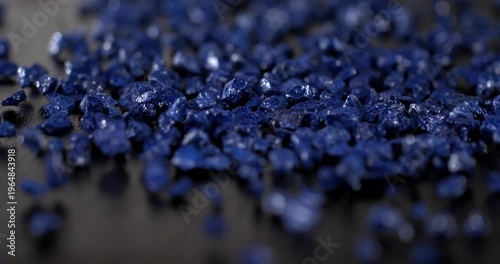 Super slow motion, Tiny Gemstones Cascade Peacefully. Delicate Lapis Fragments Scatter Softly Across Smooth