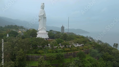 Aerial view of the Lady Buddha statue at the Linh Ung Pagoda in Da Nang, Vietnam. Tourists visit the temple to worship and enjoy the views of the city and coastline.