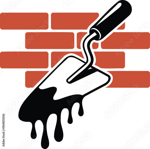 Trowel with black substance on brick wall background for construction work and DIY projects