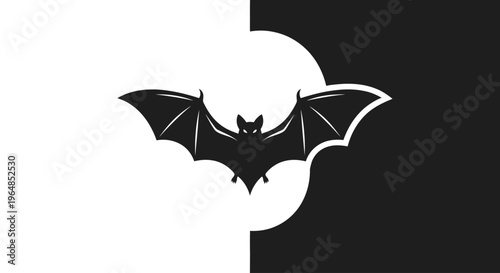 A black silhouette of a flying bat.
