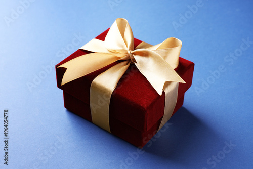 Beautiful velvet gift box on blue background, closeup