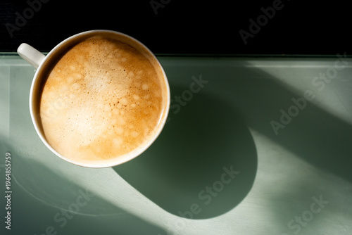 cup of coffee on the table, with morning sunshine