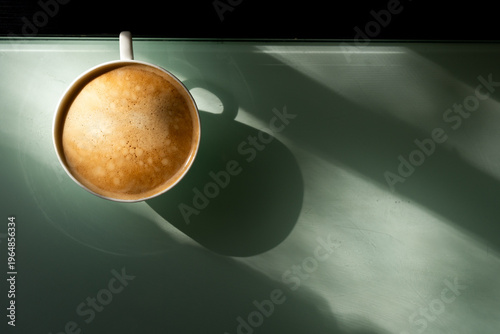 cup of coffee on the table, with morning sunshine