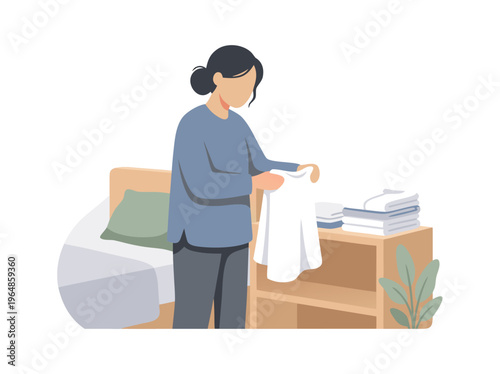 Woman Folding Clothes Next to Bed.