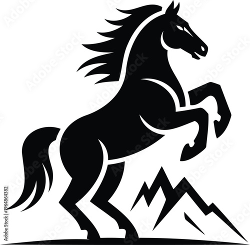 Black horse silhouette rearing up on hind legs in front of mountains