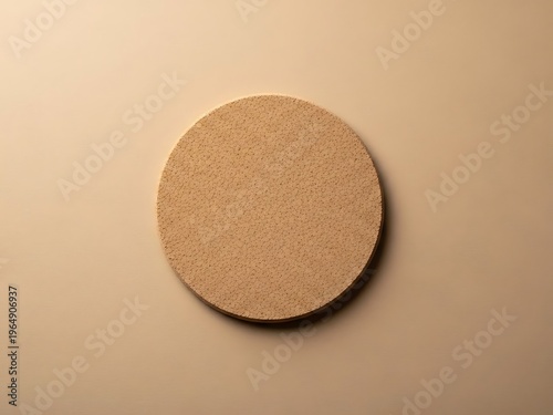 Round beige platform on pastel backdrop provides neutral showcase setup