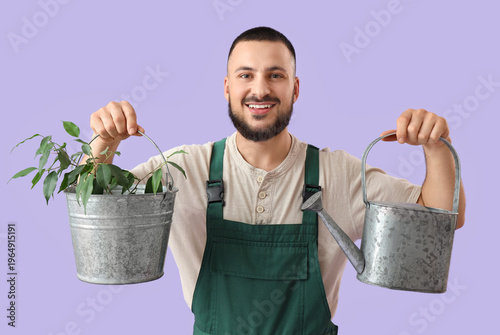 Male gardener with watering...