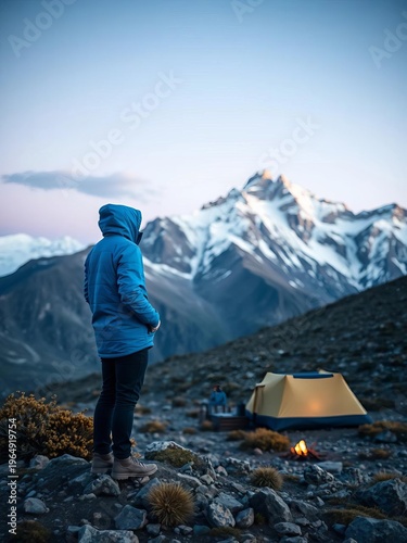 Lone figure in blue jacket surveys remote mountain camp,  adventure,  USA