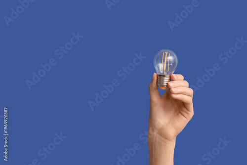 Female hand with light bulb...