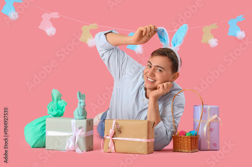 Happy young man in bunny ea...