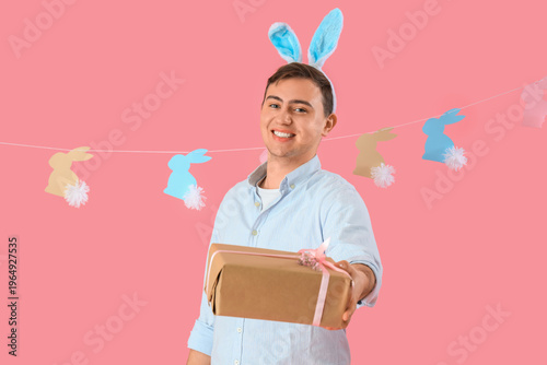 Happy young man in bunny ea...