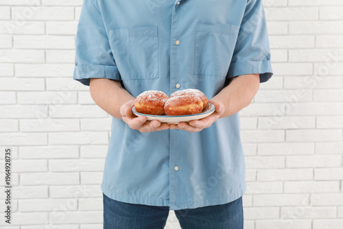 Man with sufganiyots on whi...