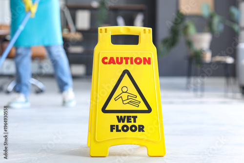 Caution sign on floor in of...