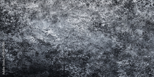 A dirty black and white grunge texture of snow and ice creates a rough gray stone wall pattern on an old concrete surface