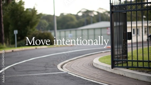 Inspirational phrase on a serene backdrop with curving pathway and gated entrance showcasing intentional movement and purposefulness