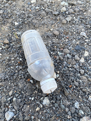 empty plastic garbage bottle on the ground