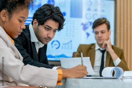 group business teamwork brainstorming discuss coworker partnership meeting statistics professionals are working in office setting. teamwork meeting looking document discussing.