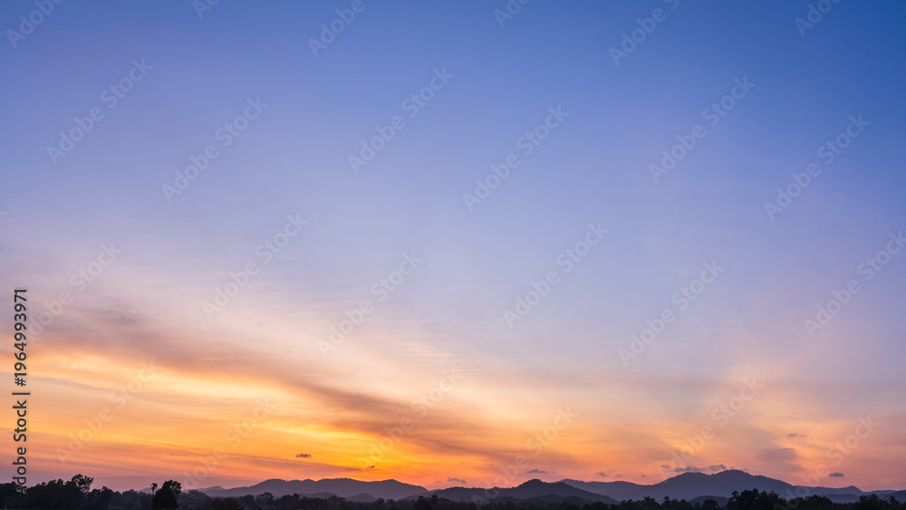 Obraz premium Sky dusk dramatic background, Summer season gold sunset landscape nature light clouds blue orange yellow color, Colorful sunrise sun cloud beauty, Mountain horizon beautiful sunlight weather sunshine