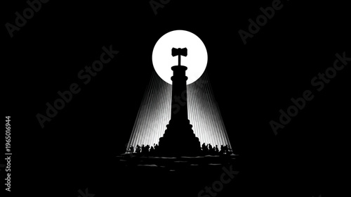 A silhouette of a monument with a hammer atop, illuminated by a spotlight, surrounded by people