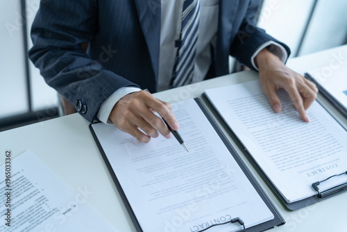 Obraz na płótnie Lawyer in suit checking contract document on table