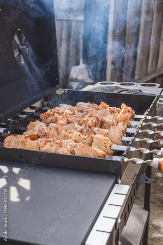 The meat is grilled outside on a barbecue