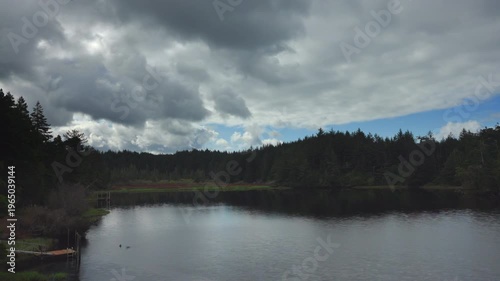 Clouds moving over lake and forest