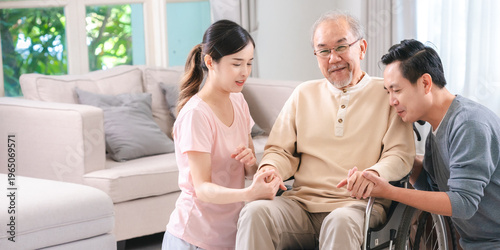 Elderly man caregiver and family member in bright living room supportive caring wheelchair home care intergenerational compassion happiness togetherness