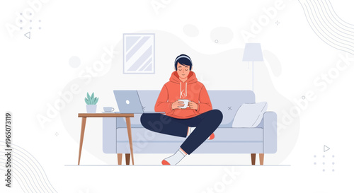 Young man relaxing on sofa with laptop and coffee, listening to music