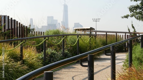 New York City downtown skyline and Little Island pier park in Midtown of Manhattan, United States. Financial district cityscape, world trade center and urban garden oasis on pillars in Chelsea, USA.