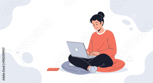 Young woman working on laptop computer while sitting cross-legged on floor cushion
