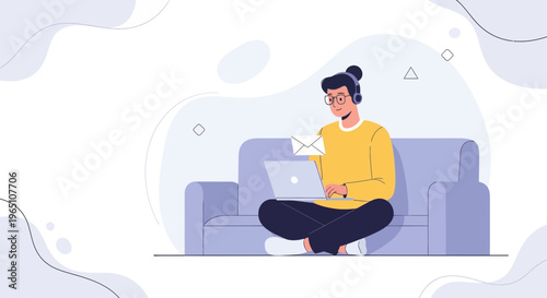 Young man with headphones working on laptop on sofa, receiving email notification