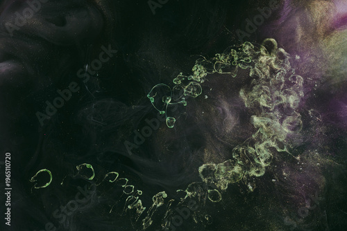 Abstract colorful green smoke on black background. Moving flow of paints, fluid liquid art, space sky