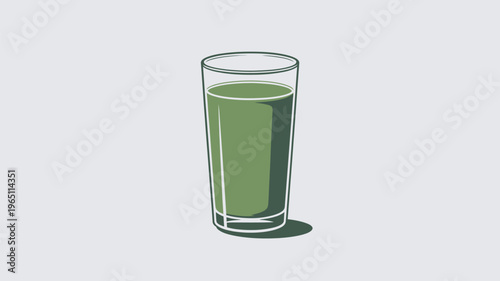 A glass of green juice on a plain background