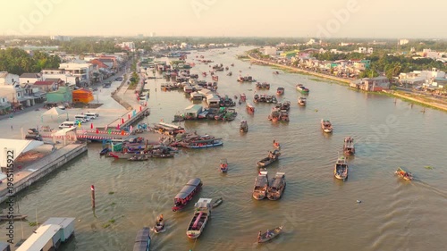 Aerial view of Cai Rang floating market, Can Tho, Vietnam. It is famous market in Mekong Delta, Vietnam. Tourists have breakfast on a boats, buy and sell food, vegetable, fruits on boat, ship