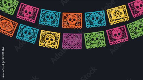 Colorful Mexican papel picado banners with intricate sugar skull designs for Day of the Dead celebrations hanging on a dark background.