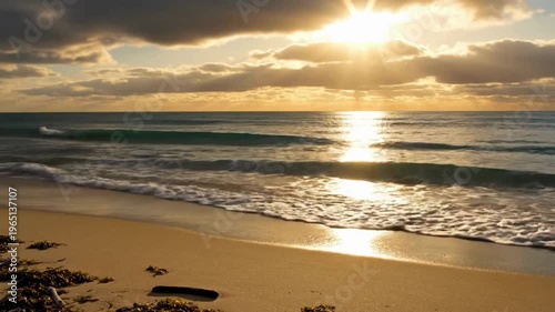 Calming Waves on Sandy Beach Transitioning to Golden Sunset