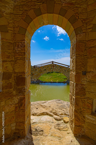 Looking through stone arch on bridge in Old stone monastery of Saint Georgios the Spilaion near city Limassol, Cyprus