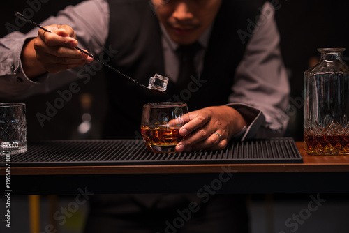 Bartender Holding Out a Glass of Premium Whiskey to Customer