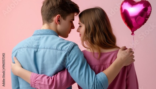 A guy and a girl are sitting in a park, smiling, and the girl is holding a balloon on a string.	
