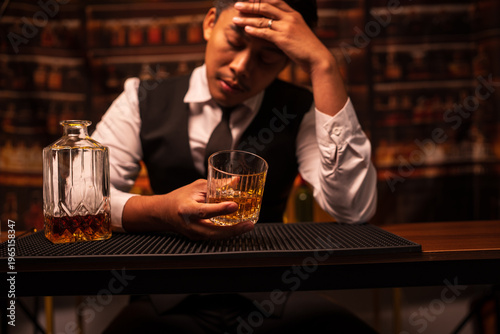 Bartender Holding a Glass of Premium Whiskey on Bar Counter