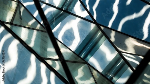Geometric glass panels casting wavy light shadows indoors