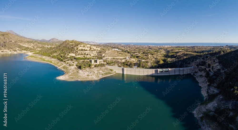 Obraz premium Drone Panoramic view of the dam infrastructure at Amadorio Reservoir, Spain