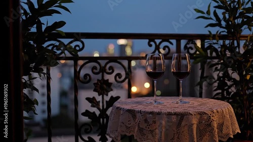 Romantic Balcony with Wine Glasses on Table Mid Shot Cozy Evening Scene